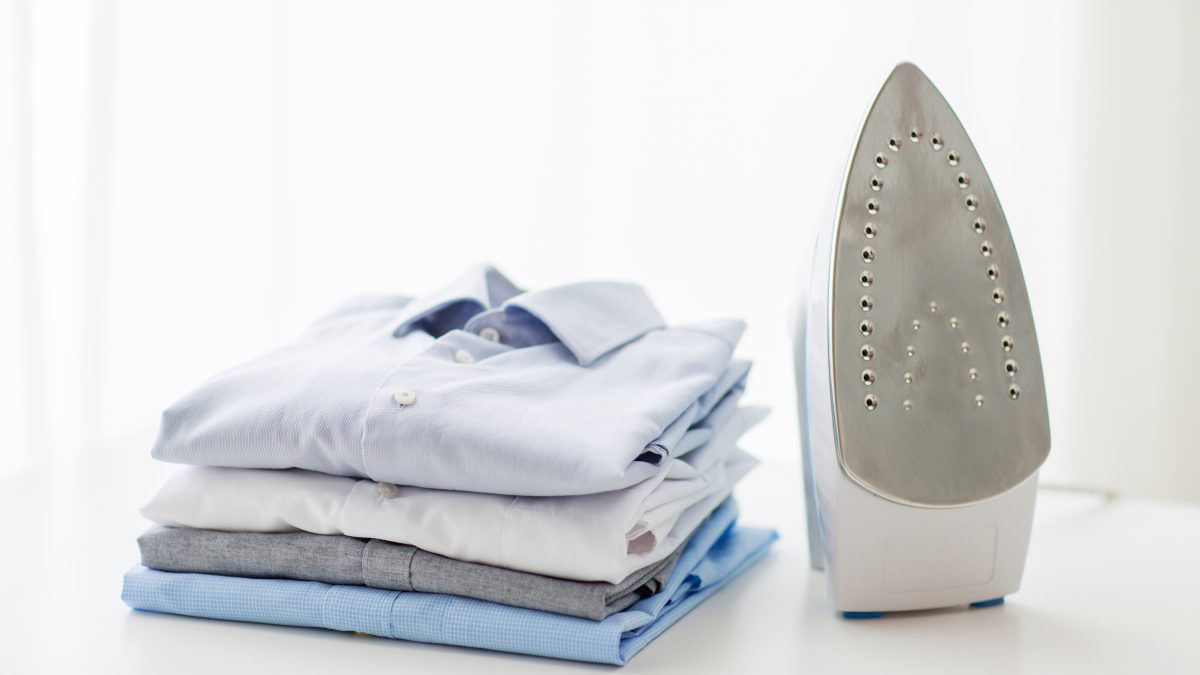 Folded shirts and an iron