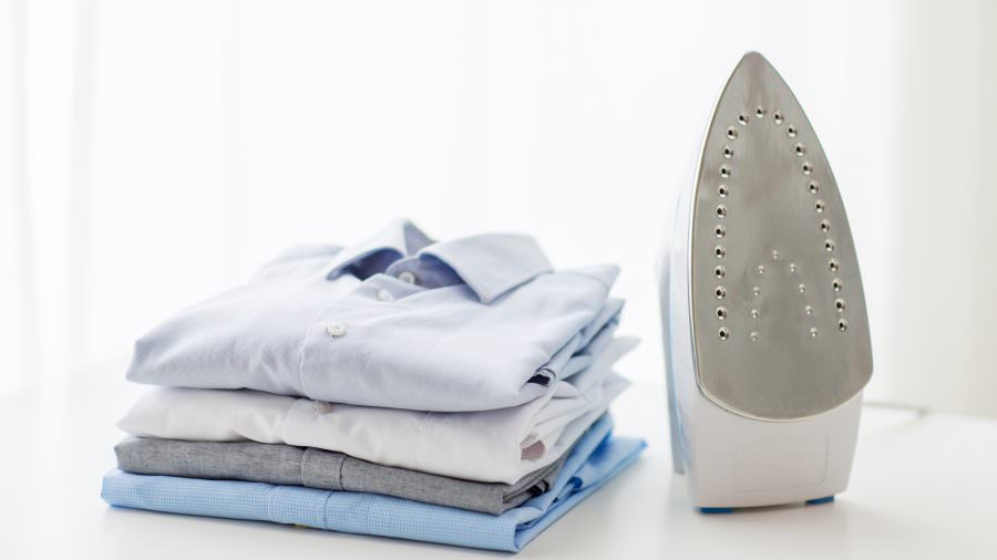Folded shirts and an iron